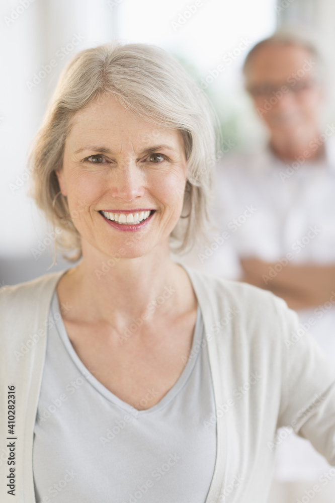 Portrait of senior woman, man in background Portrait of senior woman, man in background