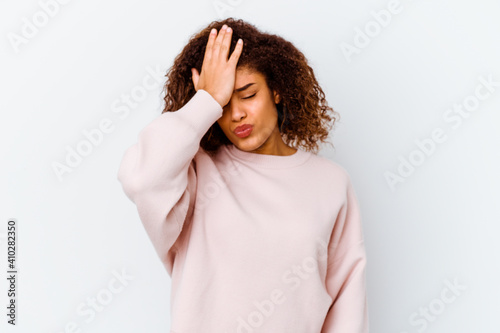 Young african american woman isolated on white background forgetting something, slapping forehead with palm and closing eyes.