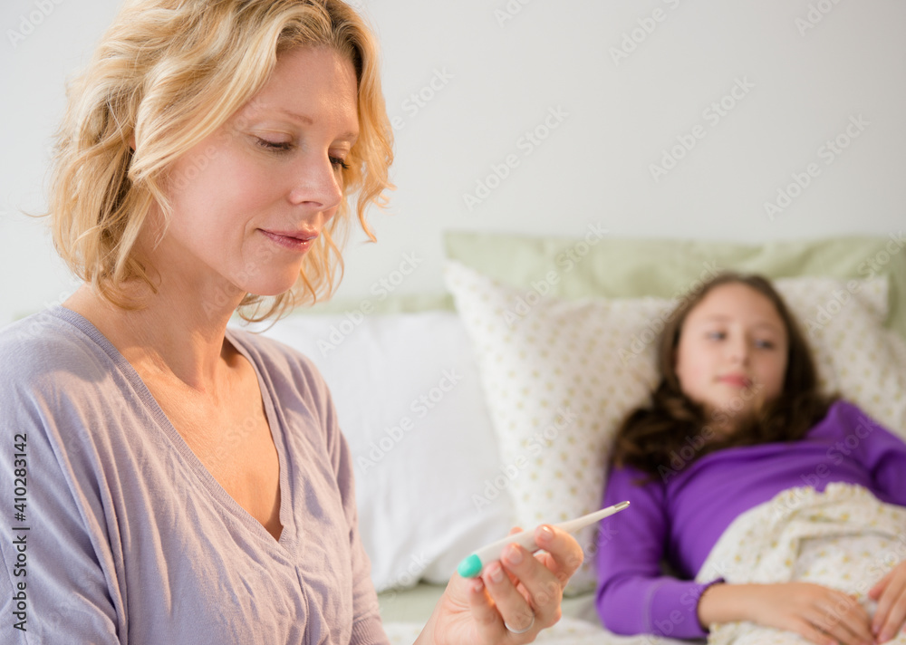 Mother checking temperature to daughter (8-9) Mother checking temperature to daughter (8-9)