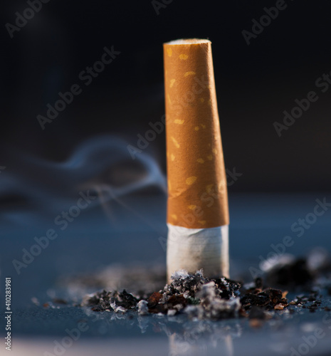 Close up of cigarette butt on black background photo