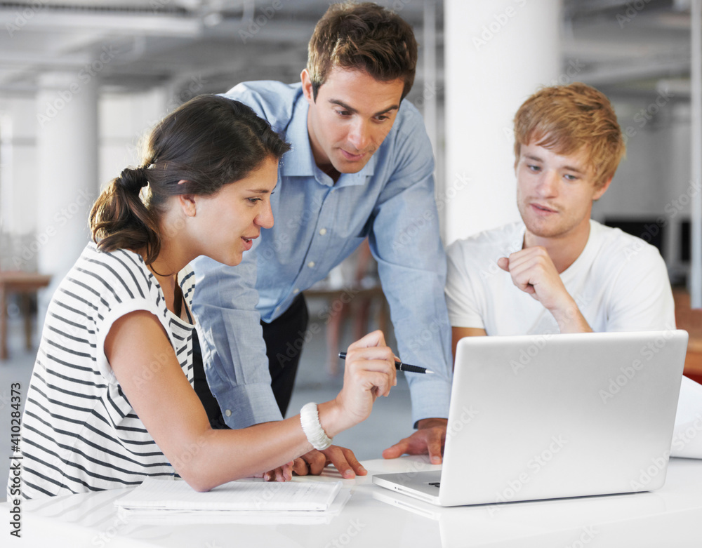 Coworkers looking at laptop Coworkers looking at laptop