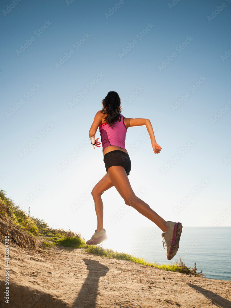 USA, California, San Diego, Woman jogging along sea coast USA, California, San Diego, Woman jogging along sea coast