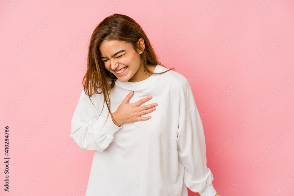Young skinny caucasian teenager girl laughing keeping hands on heart, concept of happiness. Young skinny caucasian teenager girl laughing keeping hands on heart, concept of happiness.