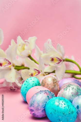 Easter eggs and orchid flower on a pink backdrop. Happy easter food and decorations, Orthodox easter celebration, spring theme, happy easter festive food  
