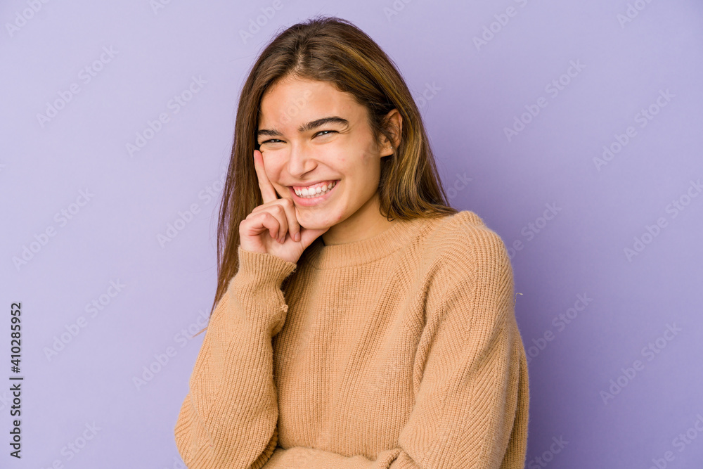 Young skinny caucasian girl teenager on purple background smiling happy and confident, touching chin with hand. Young skinny caucasian girl teenager on purple background smiling happy and confident, touching chin with hand.
