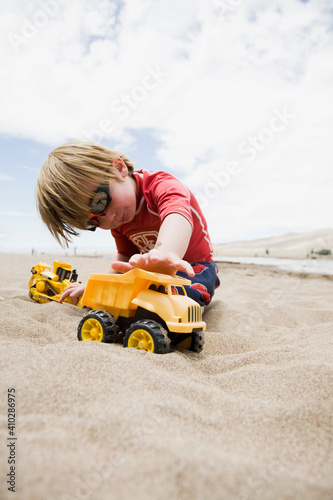 Wallpaper Mural Boy (4-5) playing with truck in sand Torontodigital.ca