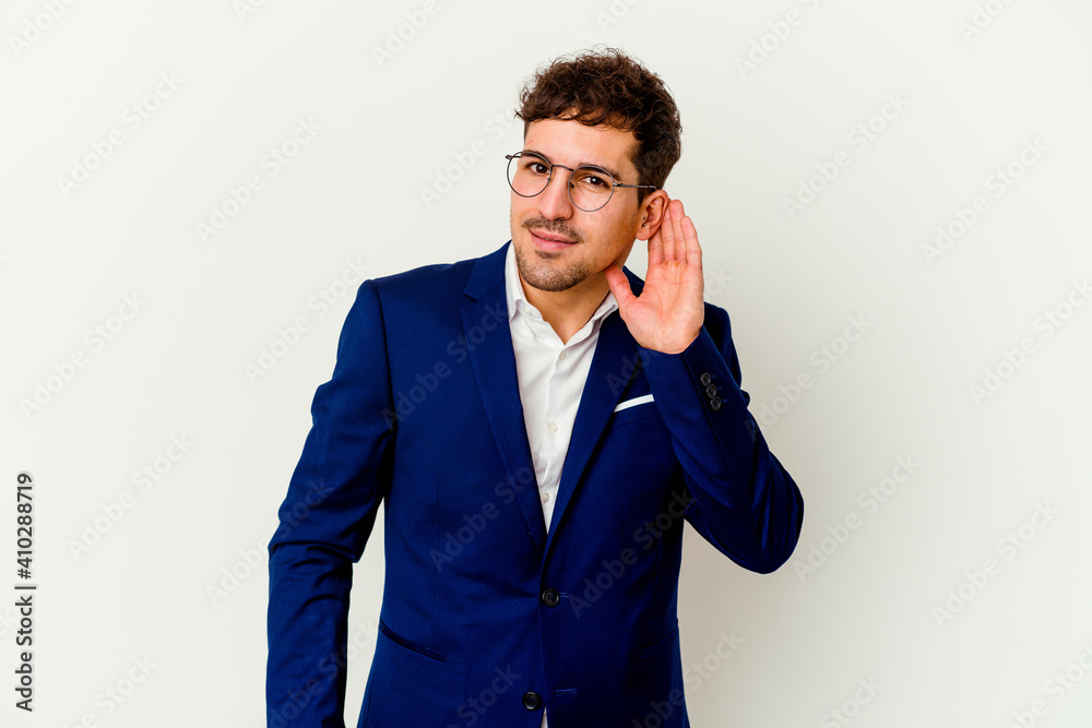 Young business caucasian man isolated on white background trying to listening a gossip. Young business caucasian man isolated on white background trying to listening a gossip.