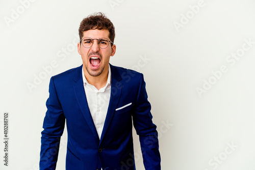 Young business caucasian man isolated on white background shouting very angry, rage concept, frustrated.