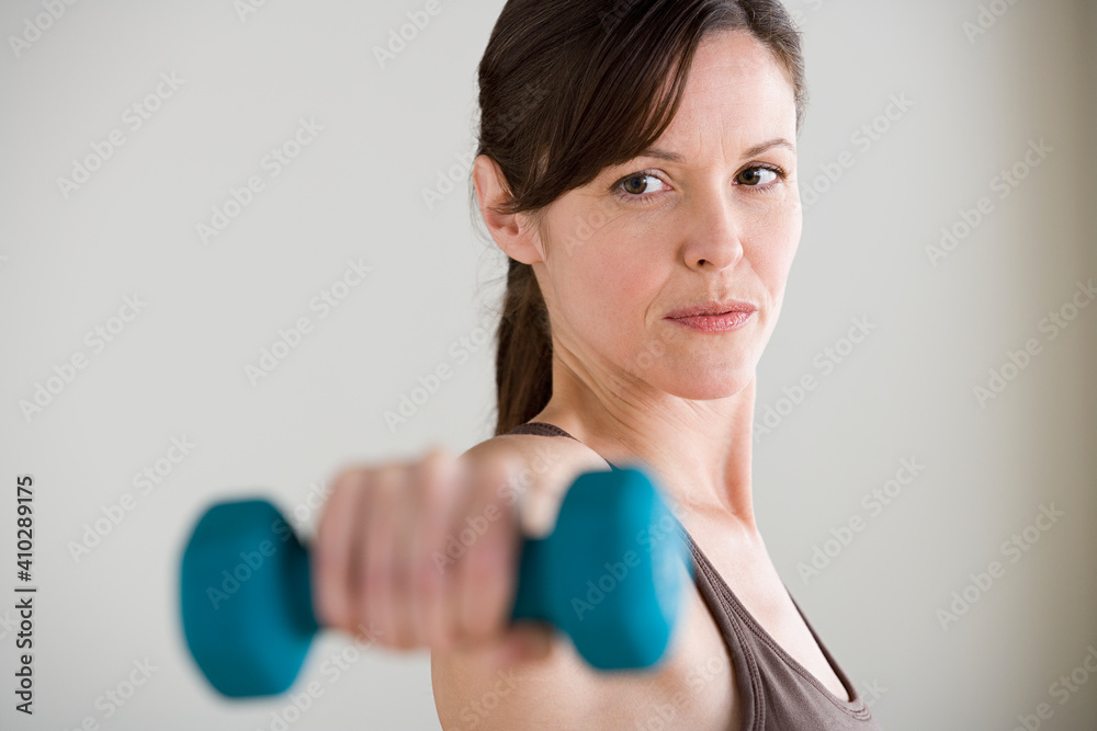 Portrait of woman lifting dumbbell Portrait of woman lifting dumbbell