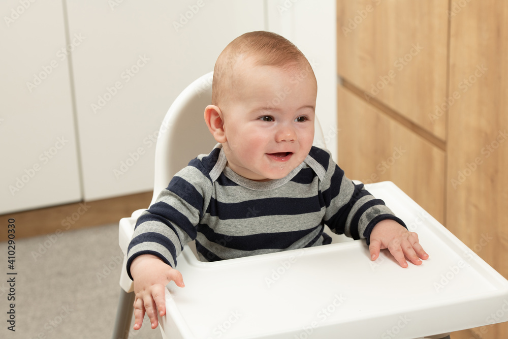 Portrait of a Happy Baby in the Highchair
