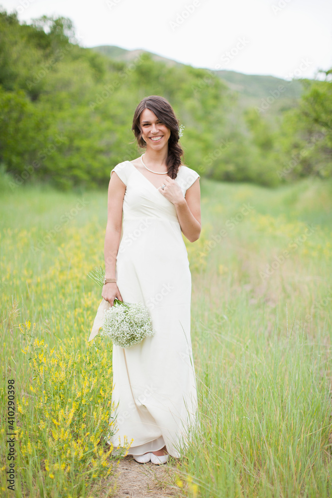 Portrait of woman wearing white dress and holding white flowers Portrait of woman wearing white dress and holding white flowers
