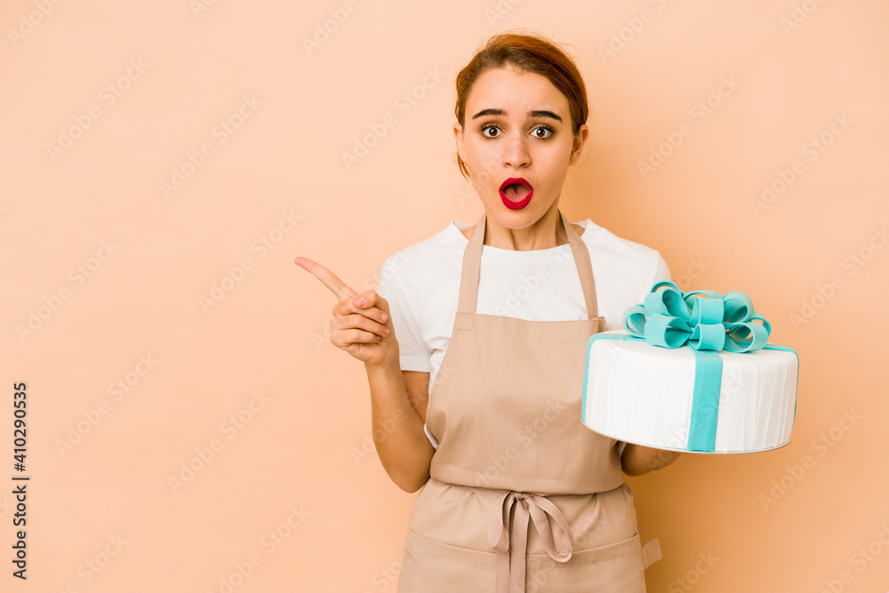 Young skinny arab pastry chef woman pointing to the side Young skinny arab pastry chef woman pointing to the side