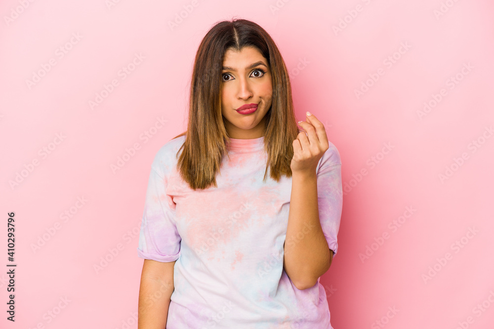 Young indian woman isolated on pink background showing that she has no money. Young indian woman isolated on pink background showing that she has no money.