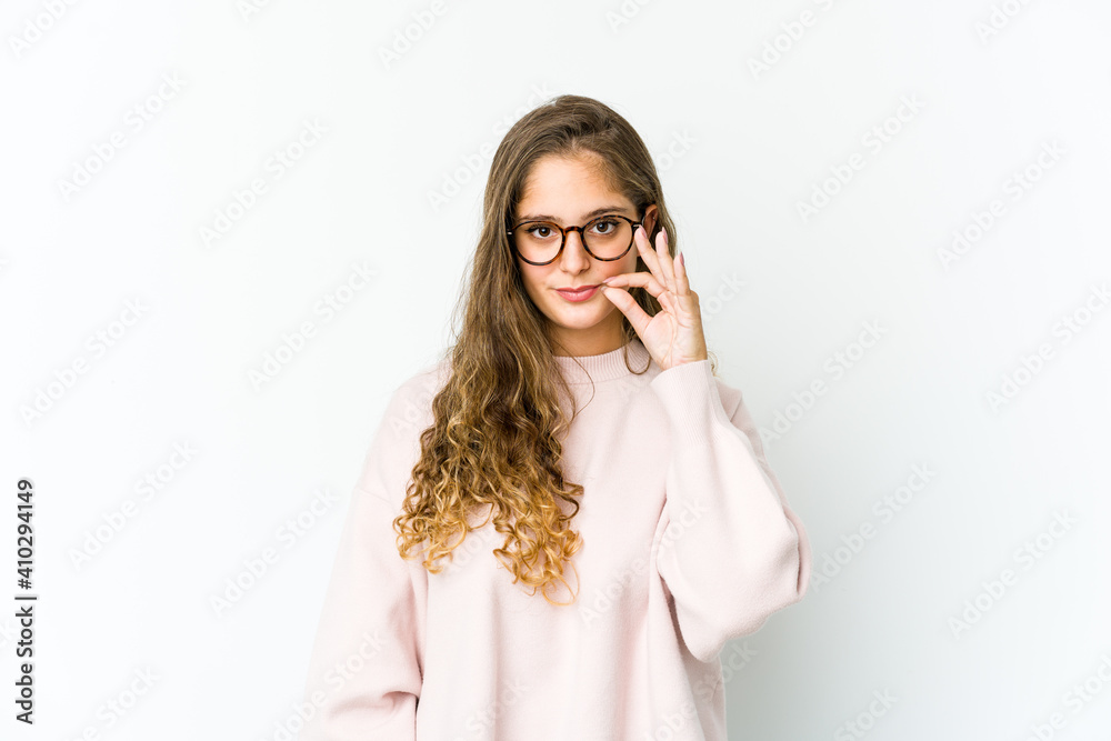 Young caucasian woman with fingers on lips keeping a secret. Young caucasian woman with fingers on lips keeping a secret.