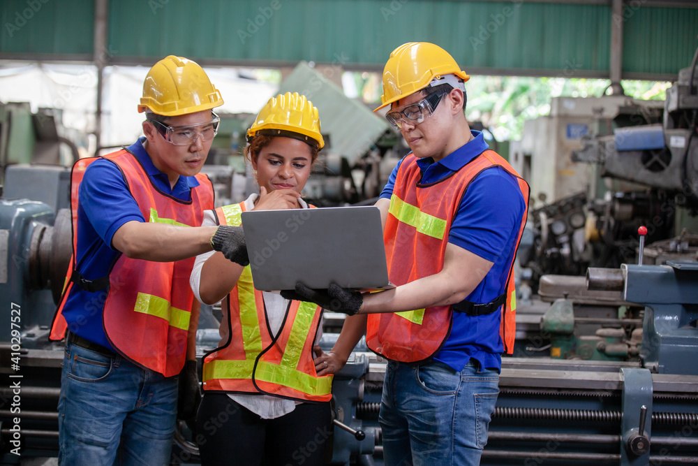 Male and Female Industrial Engineers Talk with Factory Worker while Using Laptop. industrial man engineer with laptop in a factory, Male and Female Industrial Engineers Talk with Factory Worker while Using Laptop. industrial man engineer with laptop in a factory,