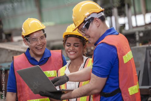 Male and Female Industrial Engineers Talk with Factory Worker while Using Laptop. industrial man engineer with laptop in a factory,