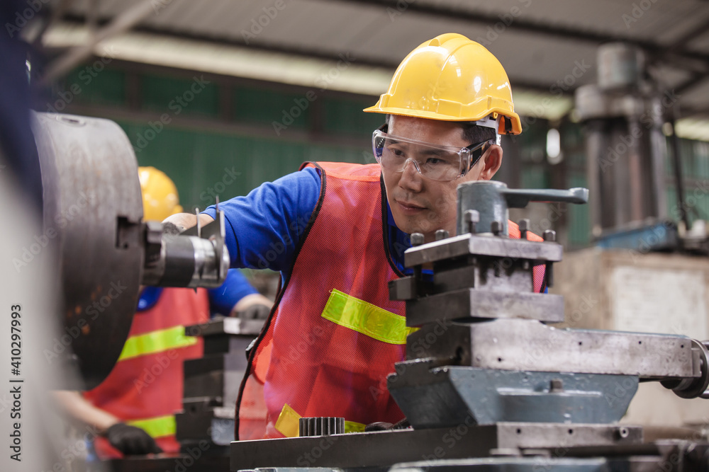 Asian Industrial workers. worker Asian in factory on the machine in factory Asian Industrial workers. worker Asian in factory on the machine in factory