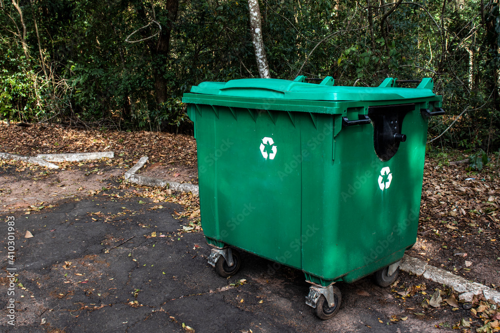 Large green recycle bin on the street of a park in Brazil Large green recycle bin on the street of a park in Brazil