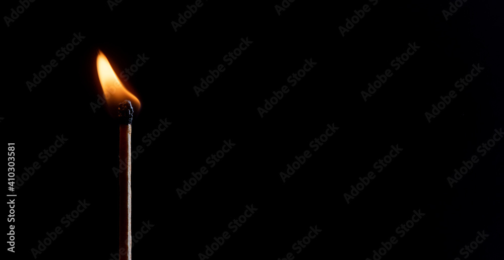 burning match on black background burning match on black background