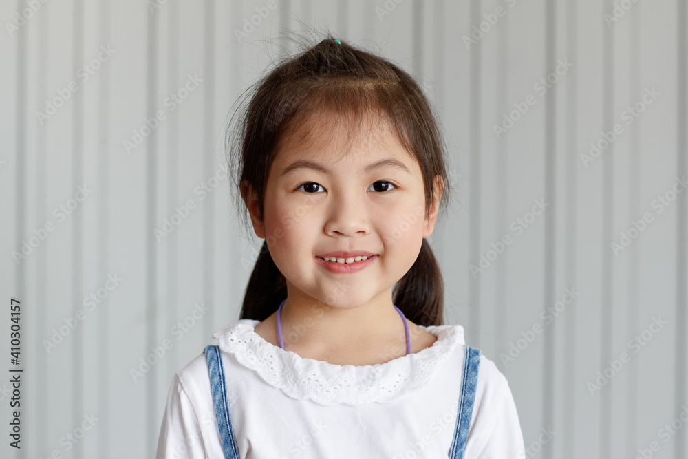 Asian good looking girl child is smiling, Happy little girl while posing at the camera on white background. Asian good looking girl child is smiling, Happy little girl while posing at the camera on white background.
