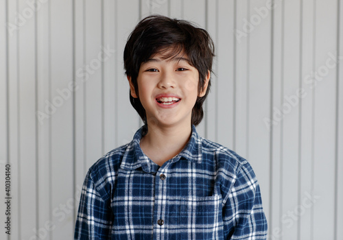 Asian good looking boy child is smiling, Happy little boy while posing at the camera on white background..