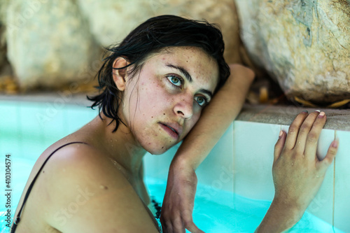 Young woman relaxing in spa swimming pool photo