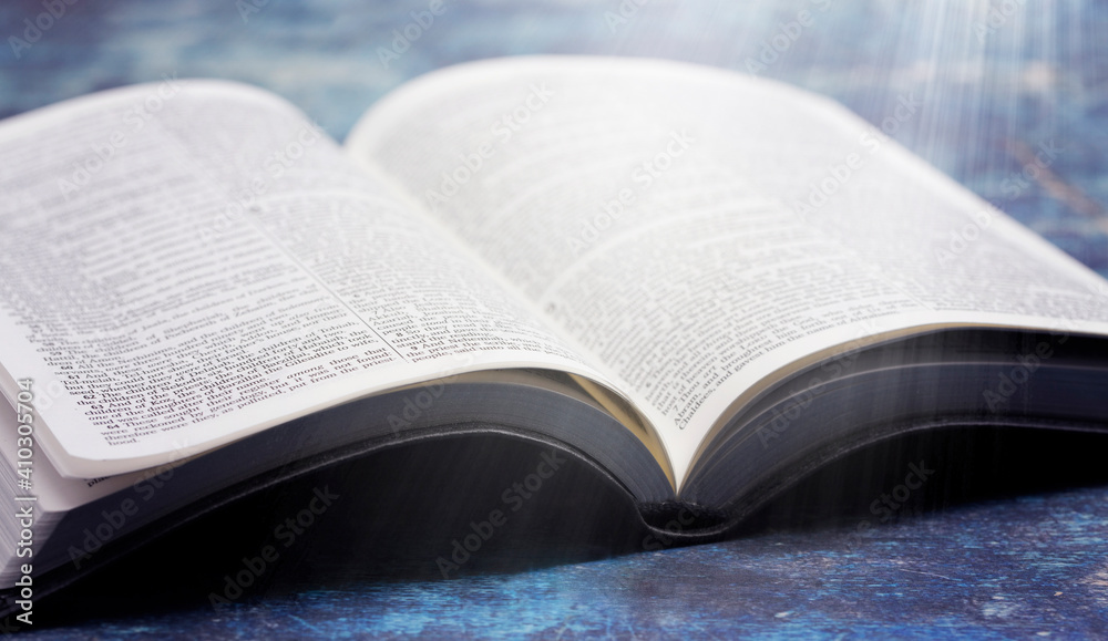 Bible Open on a Rustic Blue Wooden Table Bible Open on a Rustic Blue Wooden Table