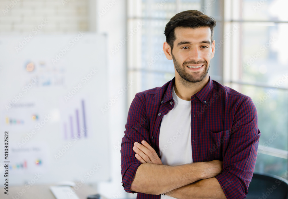 Businessman standing and folding his arms in office. Businessman standing and folding his arms in office.