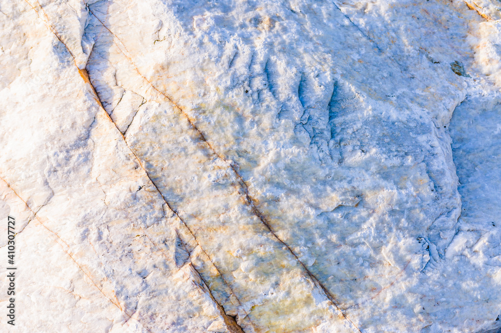close up detail of rock surface with variety of colors under natural sunlight