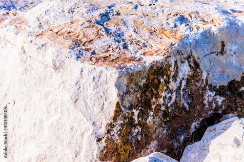 close up detail of rock surface with variety of colors under natural sunlight photo