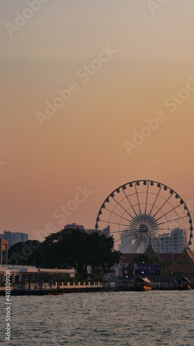 Landscape view of Farris Wheel at Chao Praya river in sunset, Bangkok, Thailand  © Veruree