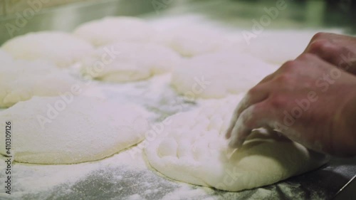 Chef is making pizza dough. Hands and dough. Cooking pizza dough. Chef preparing the dough for the pizza.