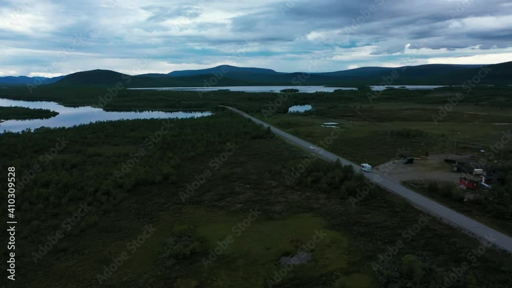 Aerial view of a motorhome driving in arctic nature, dark, cloudy day, in Lapland, Finland - tracking, drone shot Aerial view of a motorhome driving in arctic nature, dark, cloudy day, in Lapland, Finland - tracking, drone shot