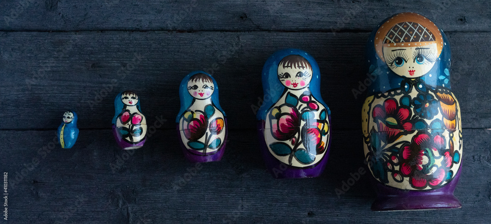 Matryoshka. Russian folk toys. On wooden background.