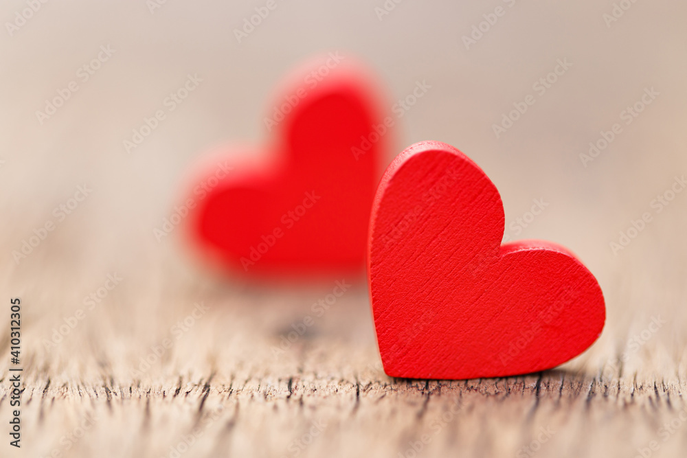 Two small red hearts made of wooden on bright white lights bokeh background. Valentine day background Two small red hearts made of wooden on bright white lights bokeh background. Valentine day background