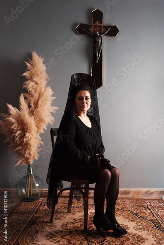 Middle-aged woman on camera in traditional Catholic dress