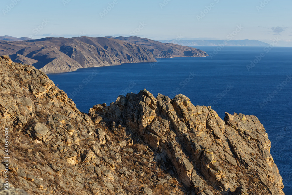 Cliffs on shore of Baikal lake and blue water Cliffs on shore of Baikal lake and blue water