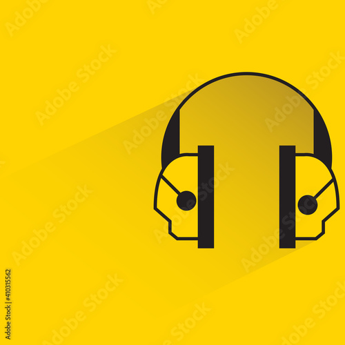 protective ear muffs with shadow on yellow background