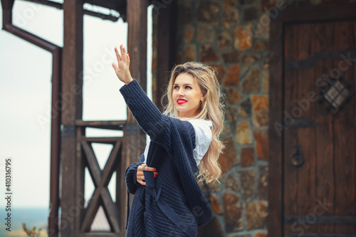 Young beautiful happy woman at a country house in nature