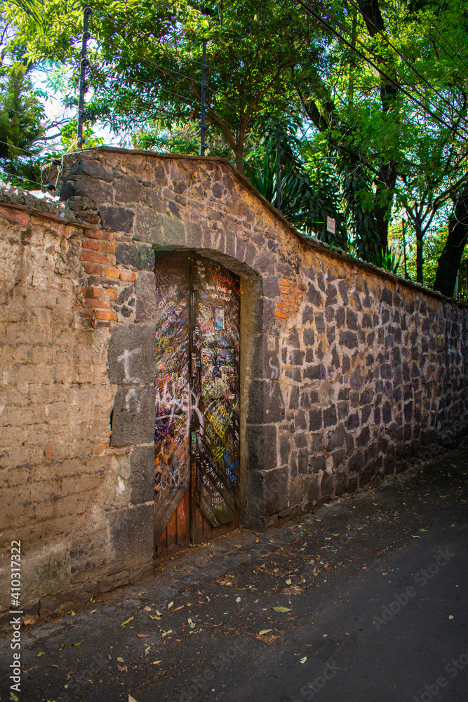 Stone wall in alley from Mexico City with trees as background