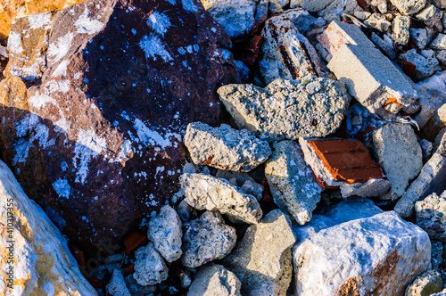 close up detail of rock surface with variety of colors under natural sunlight photo