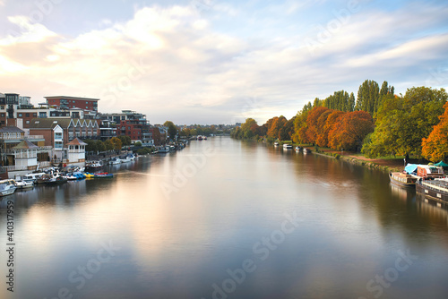 Aerial view above the River Thames surrounded by trees and buildings © Christian
