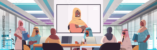 team of arabic medical specialists having video conference with female black muslim doctor medicine healthcare concept hospital meeting room interior horizontal portrait vector illustration