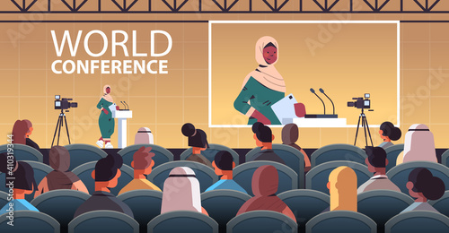 arab female doctor giving speech at tribune with microphone medical conference meeting medicine healthcare concept lecture hall interior horizontal vector illustration