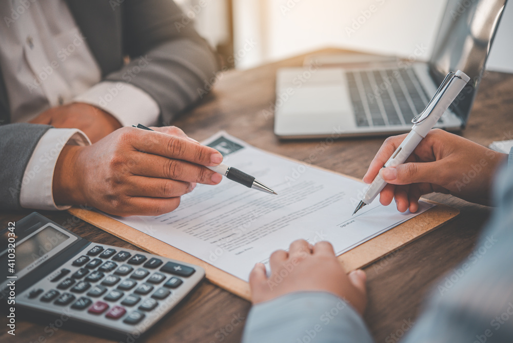 businessman is negotiating, advising, and explaining the matter of the contract to be agreed to sign the contract.