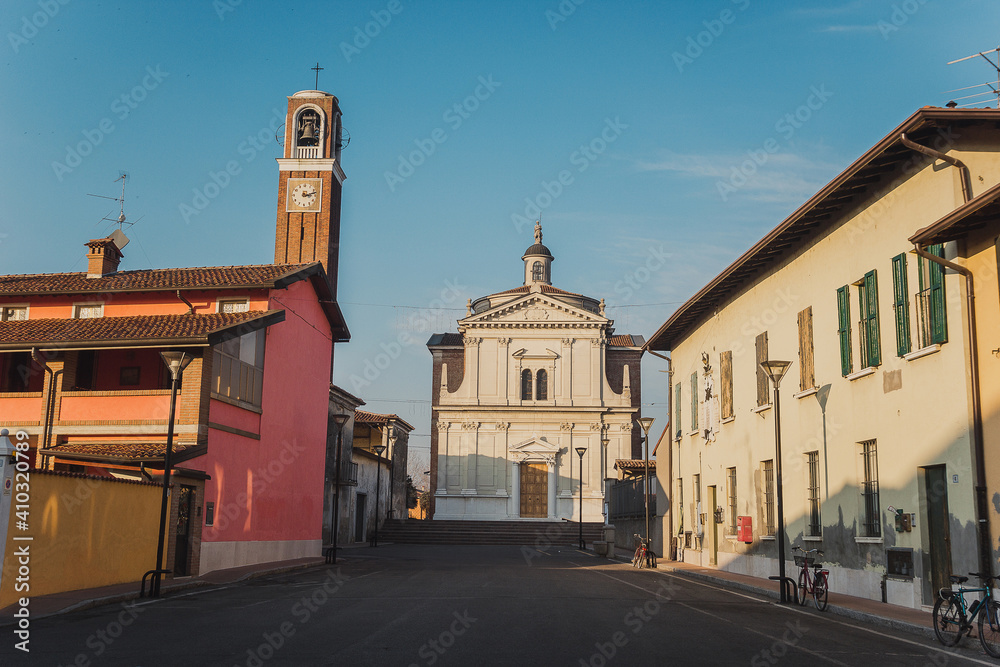 Old medieval cathedral with bell tower in the evening. Beautiful italian church. Cremezzano di San Paolo. Chiesa di San Giorgio Martire 
