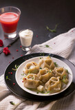 Manti or manty dumplings in a traditional bowl on wooden table. banner menu recipe place for text. frozen food. meal planning