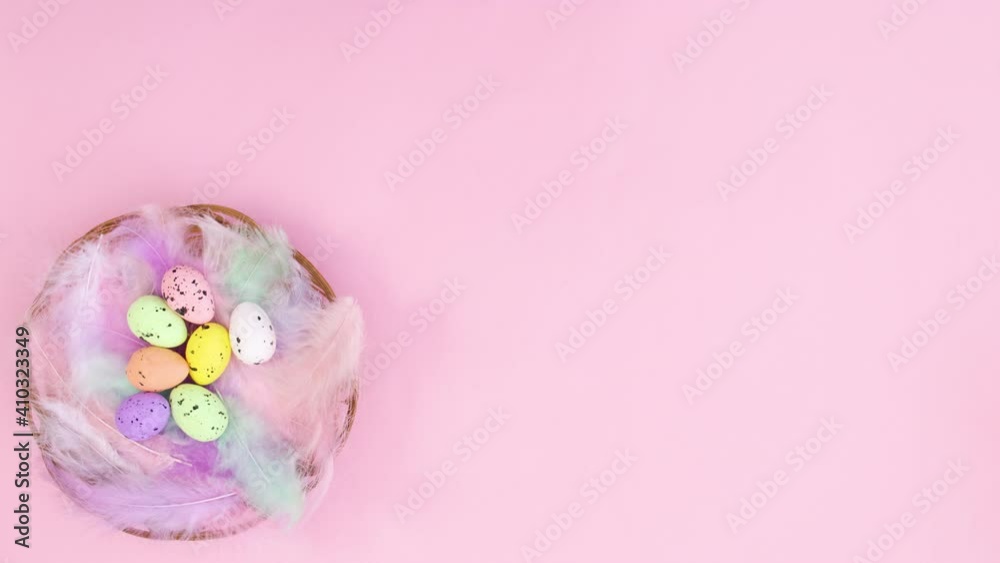 Wooden basket with Easter eggs appear on left side of pastel pink theme. Stop motion Wooden basket with Easter eggs appear on left side of pastel pink theme. Stop motion