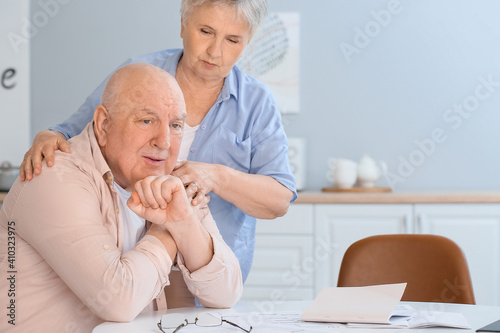 Stressed senior couple at home