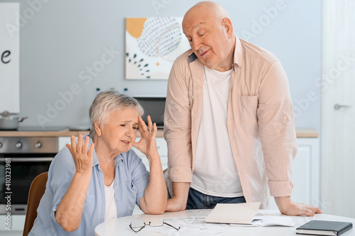 Stressed senior couple at home